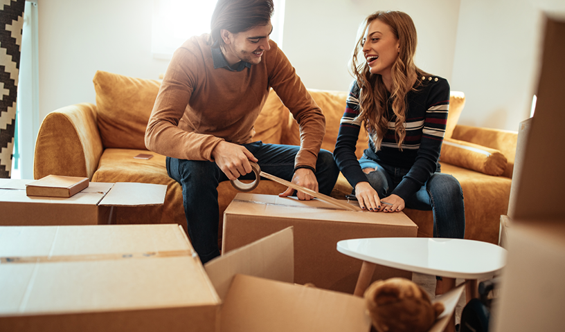 Professional movers carefully packing household items